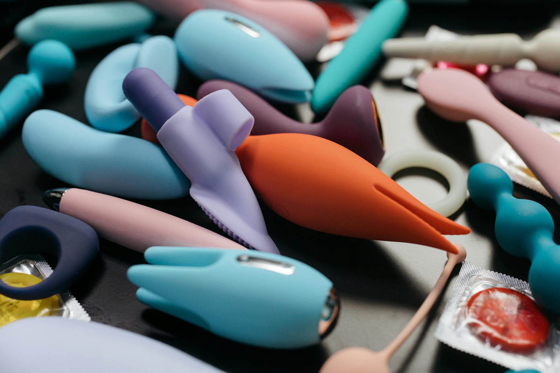 Hand holding a vibrator against a purple backdrop, symbolizing modern sensuality after 40