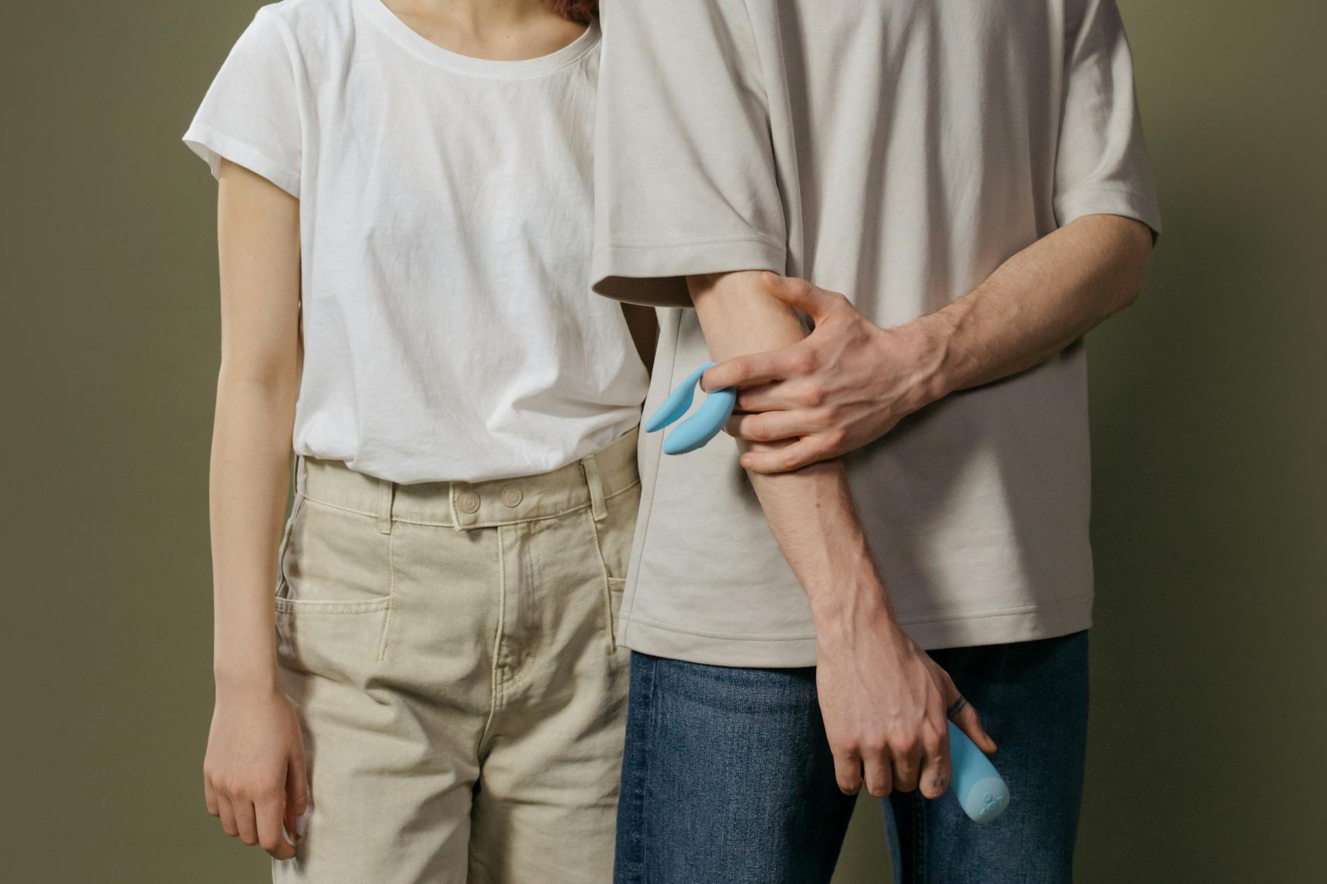 A couple holding a vibrator together, representing modern approaches to intimacy and pleasure after medication changes.