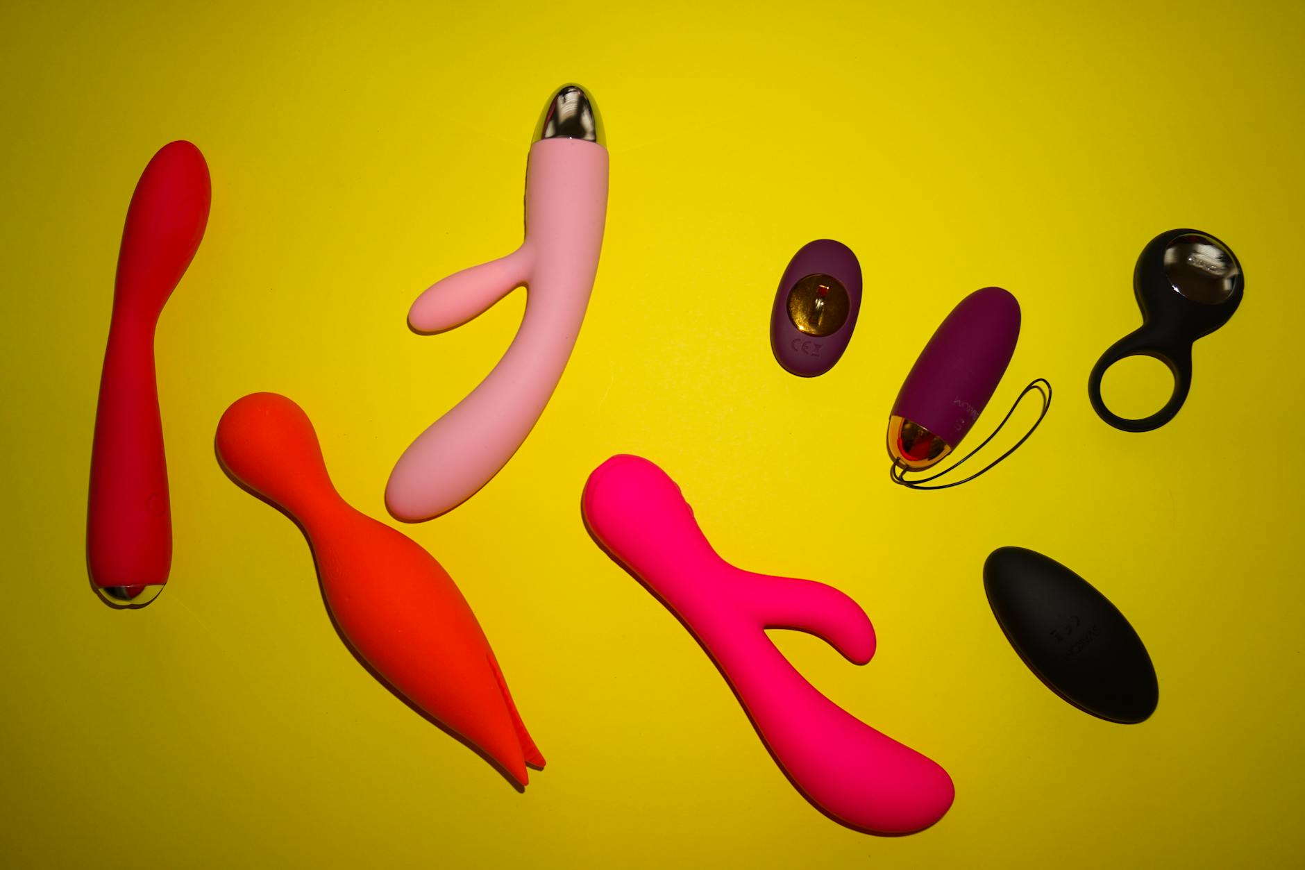 Vibrant collection of colorful lemon clitoral vibrators and adult toys on a bright surface